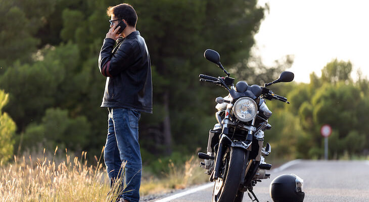 Car and motorcycle insurance bundle: man talking on the phone