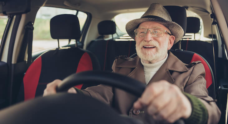 Senior wearing a hat and driving a car