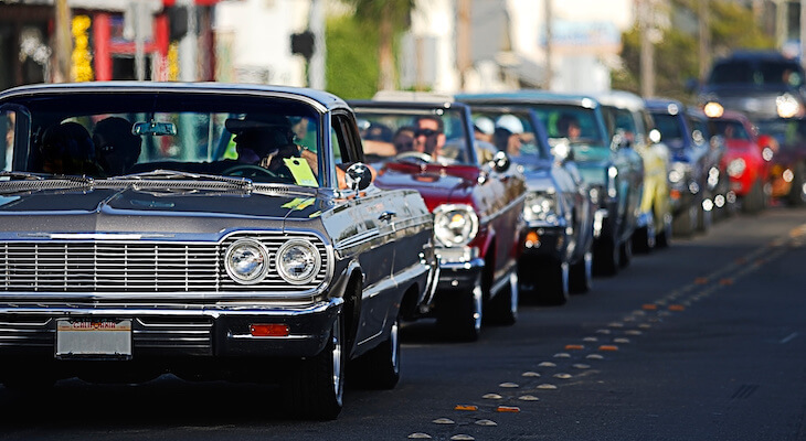 The best classic car insurance for all these classic cars lined up on a road