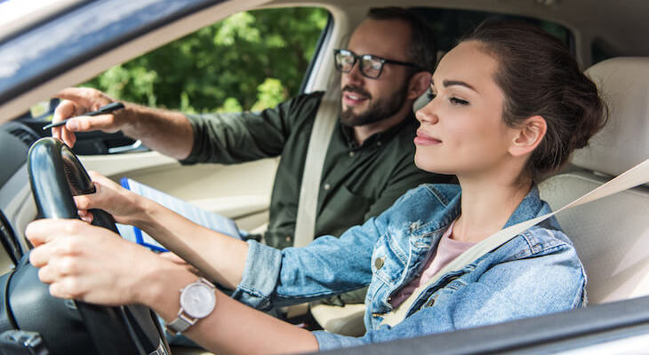 Cheapest car insurance for new drivers: person teaching another person to drive