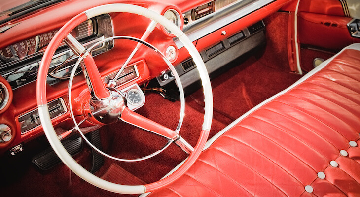 An all red interior of a classic car