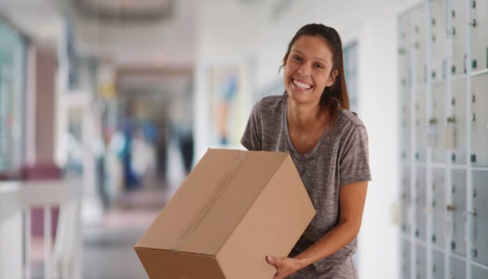 woman getting a package from the po box
