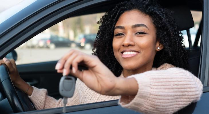 Can you negotiate car insurance: woman holding a car key