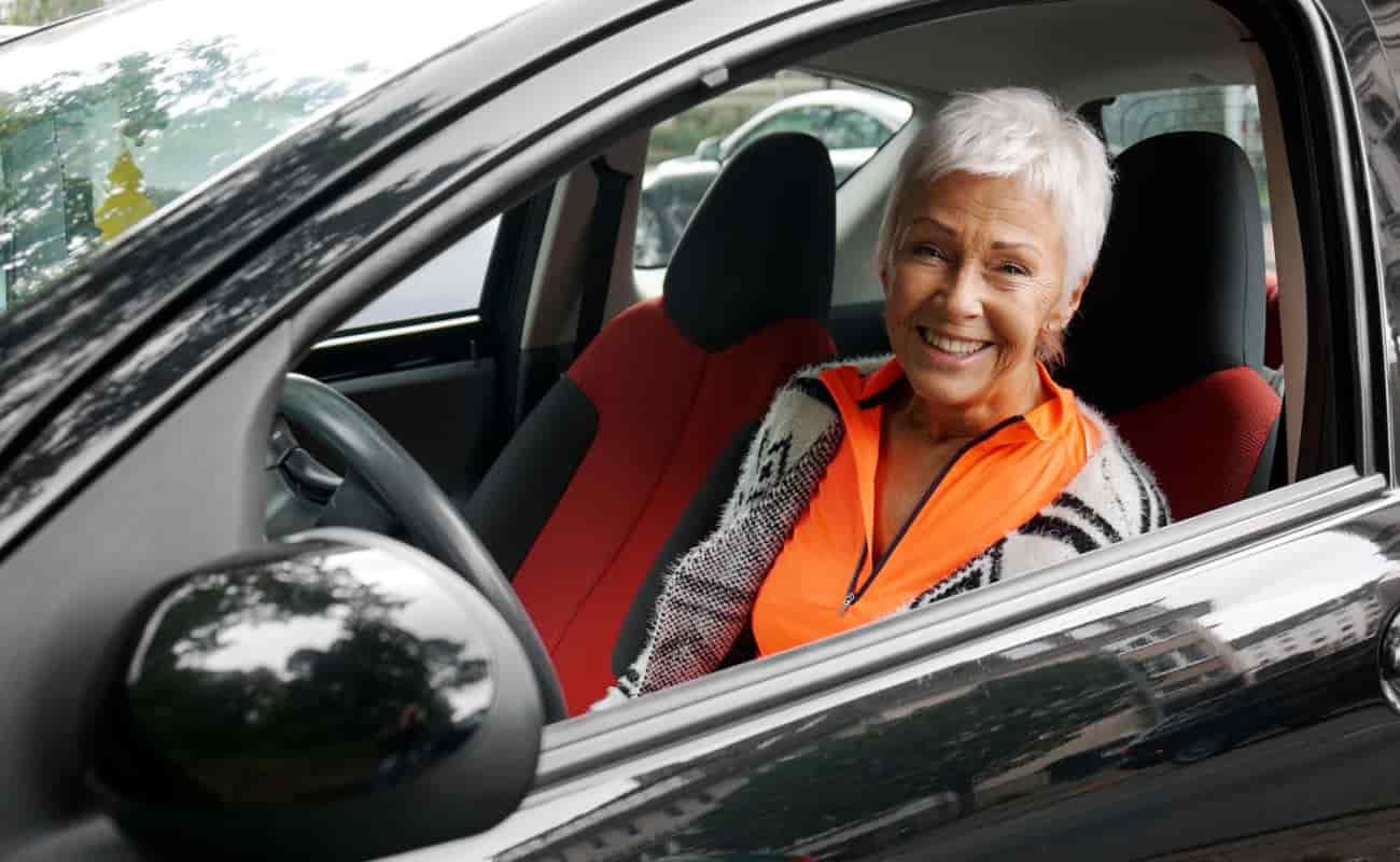 woman smiling while sitting in the car 