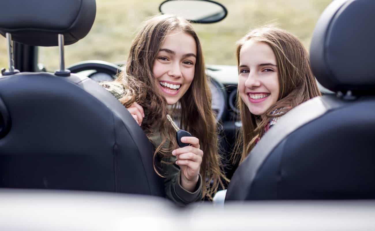 two young female drivers behind the wheel
