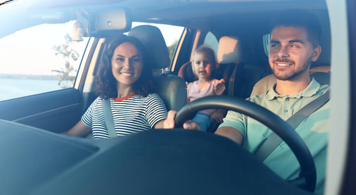 Premium car insurance: family happily riding a car