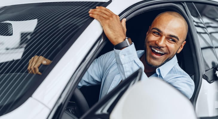 Proof of insurance: man happily riding a car