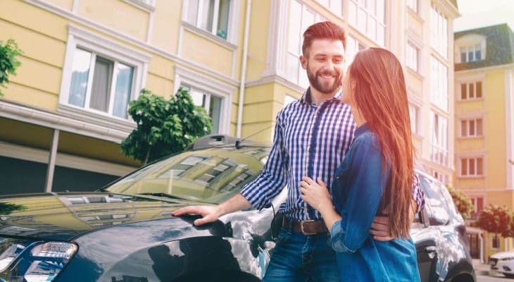 couple standing outside car