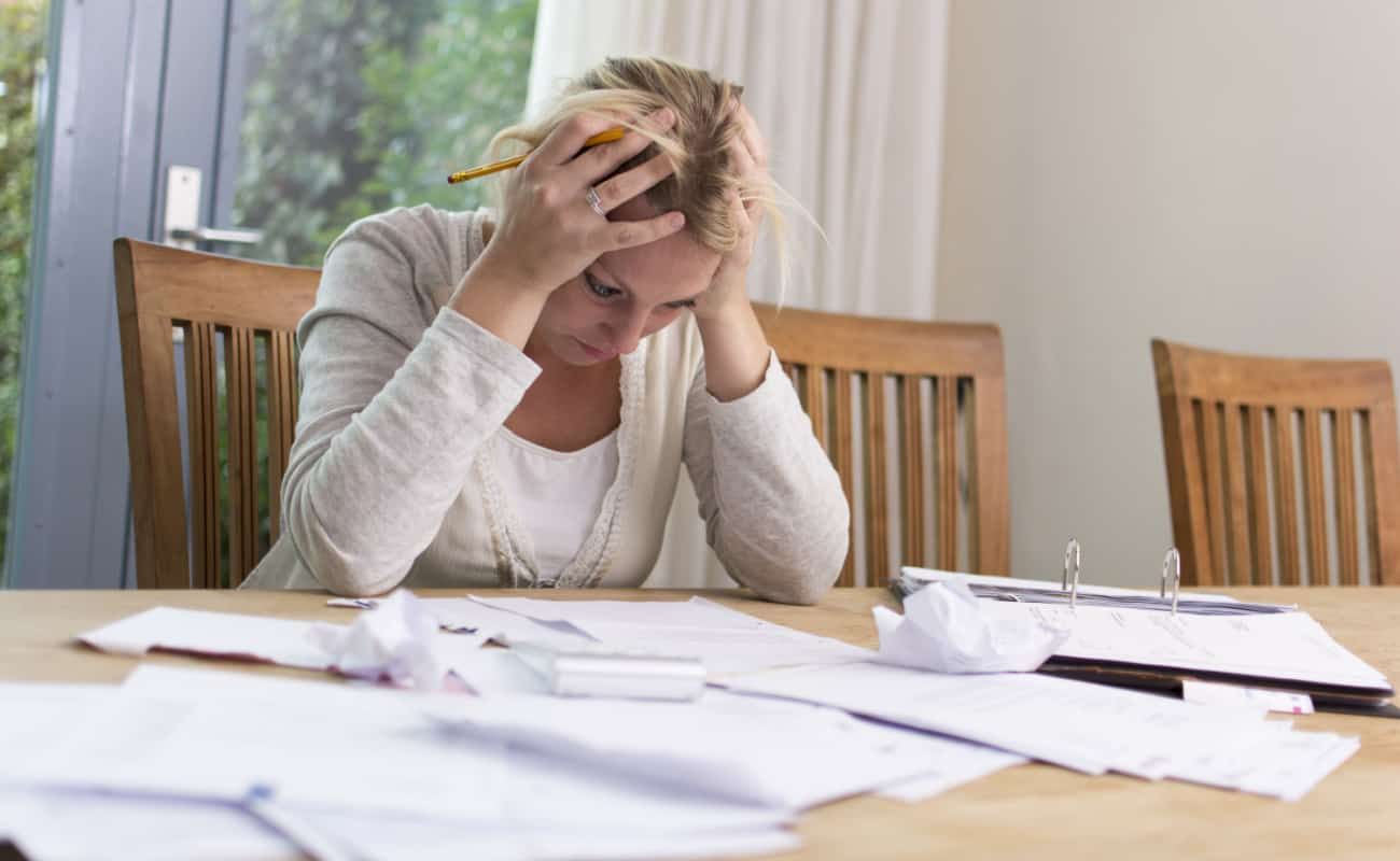 stressed woman with bad credit looking at her bills