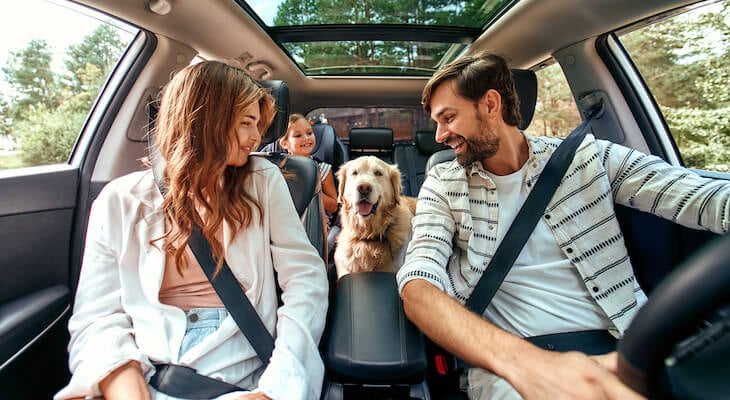 Loyalty discount: family happily riding a car