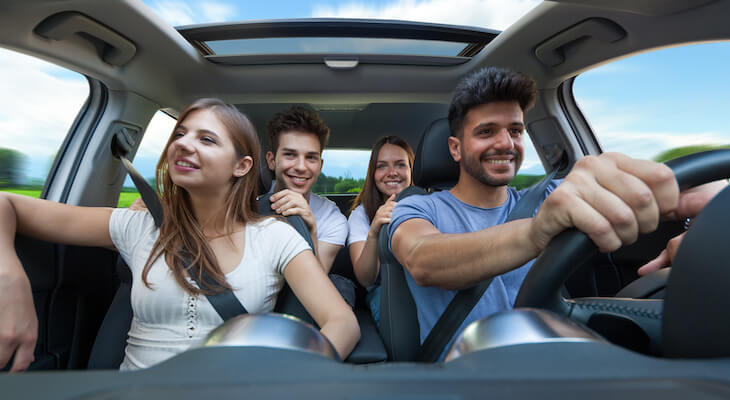 Factors that affect car insurance rates: group of friends riding a car