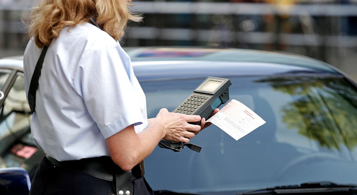 parking officer writing a ticket