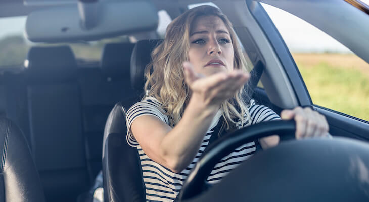 Woman frustrated at the car driving in front of her