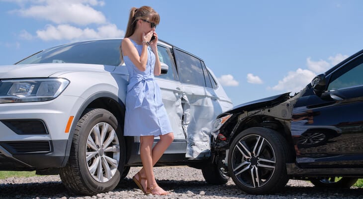 Woman talking on the phone after a car accident