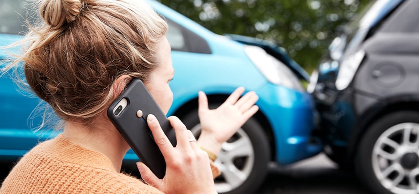 Woman calling her insurance company after a car accident