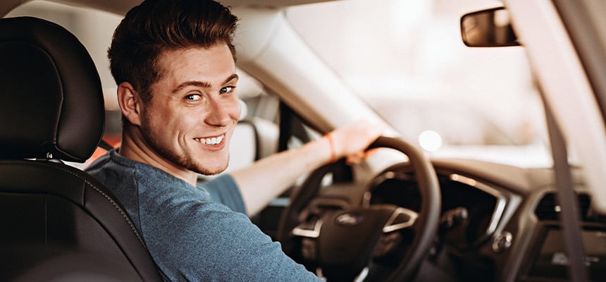 Man behind the wheel of an insured vehicle