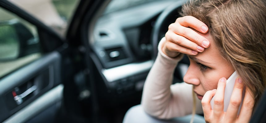 Stressed woman on the phone after a collision