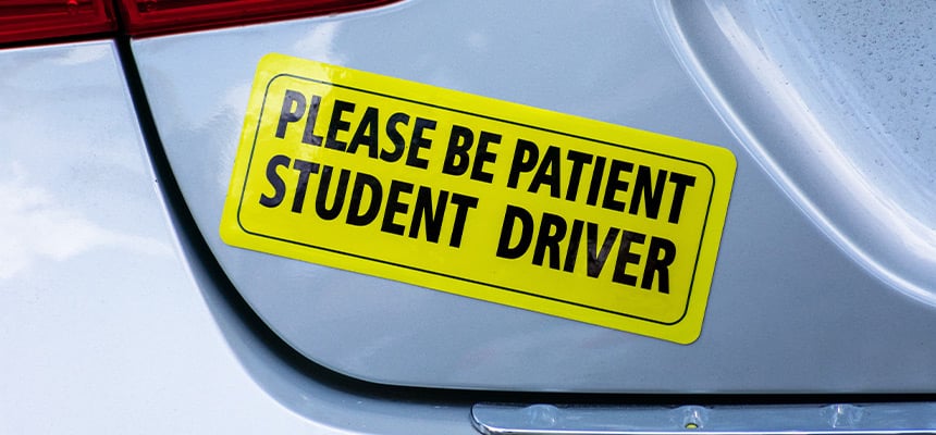 Student driver sticker on the back of a car
