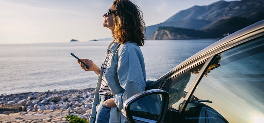 Woman using her phone to compare auto insurance rates