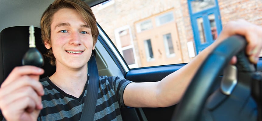 Young driver holding a car key