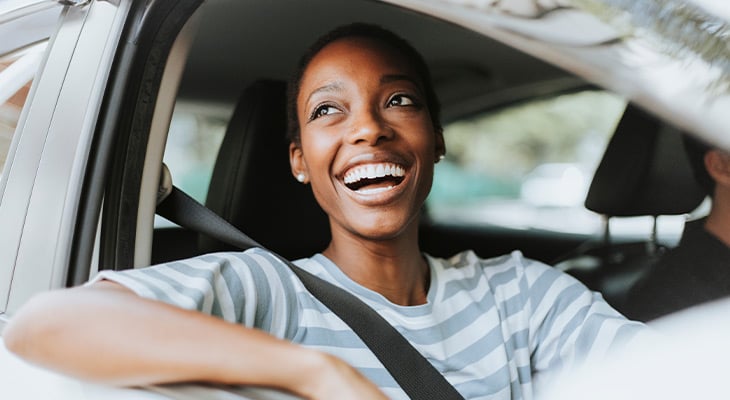 a woman smiling in a car