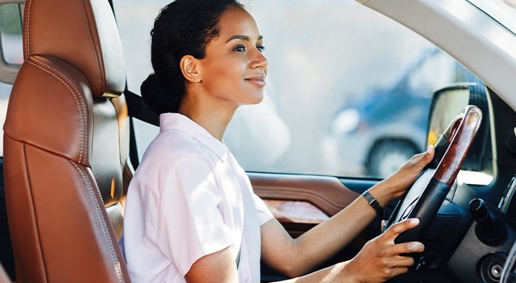 woman driving and smiling 