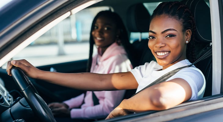 two women smiling in car