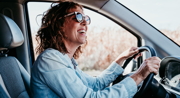 woman driving and smiling